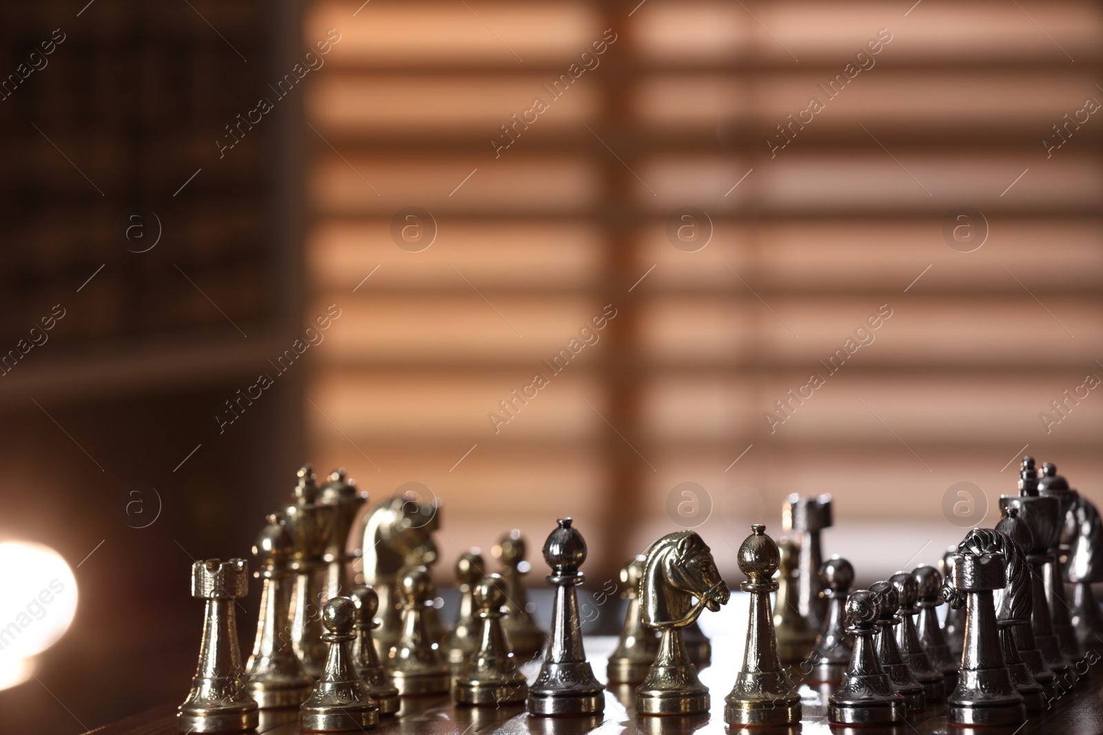 Photo of Chessboard with game pieces near window indoors, space for text