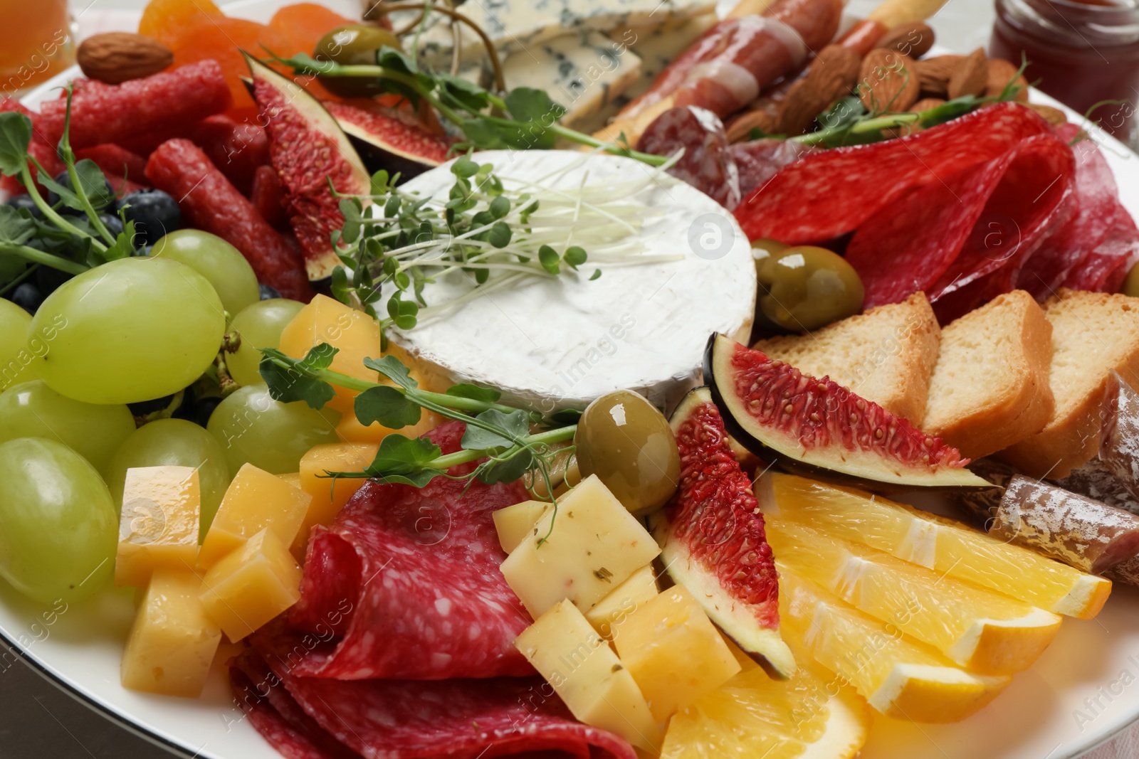 Photo of Set of different delicious appetizers on plate, closeup