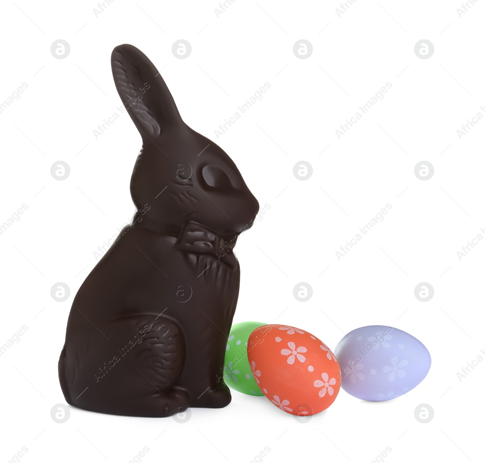 Photo of Chocolate Easter bunny and eggs on white background