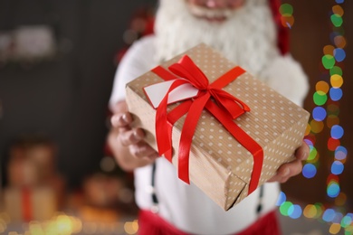 Photo of Authentic Santa Claus with gift box indoors