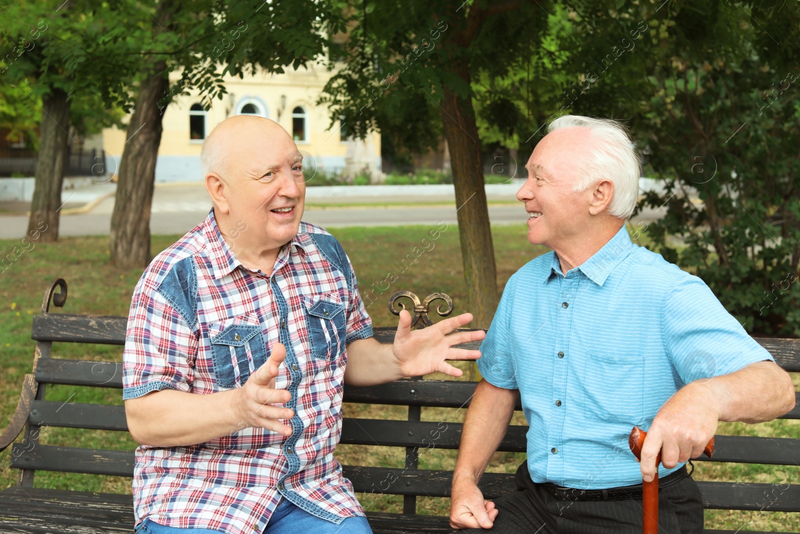 Photo of Elderly men resting on bench in park