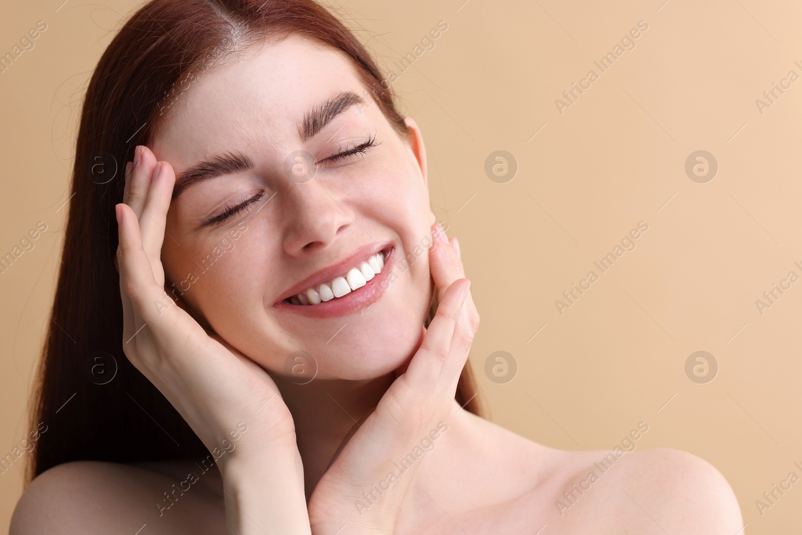 Photo of Portrait of smiling woman on beige background, closeup. Space for text