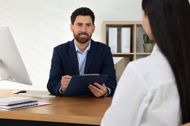 Human resources manager conducting job interview with applicant in office