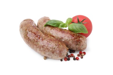 Photo of Tasty homemade sausages, peppercorns, tomato and basil leaves isolated on white