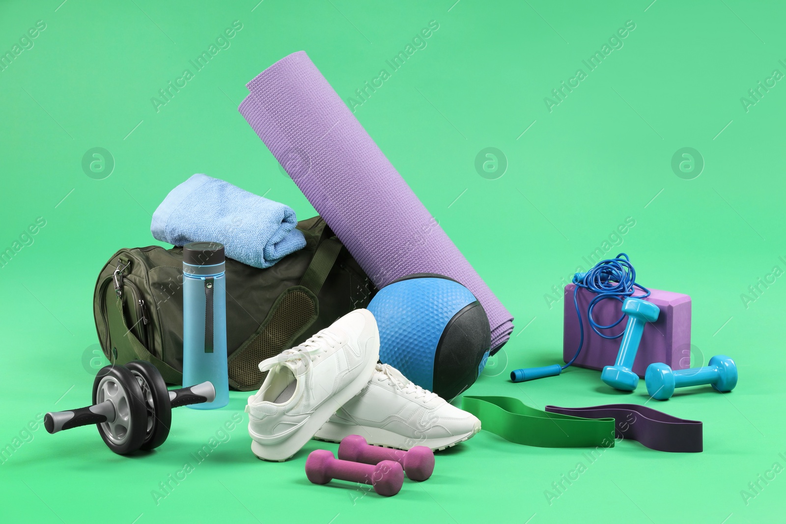 Photo of Many different sports equipment on green background