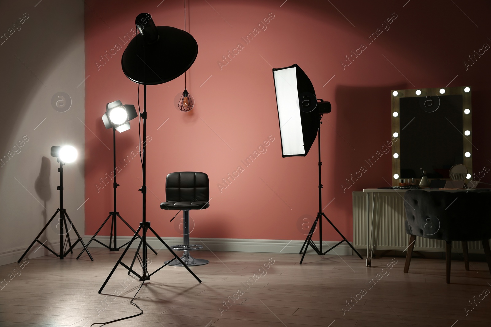 Photo of Different professional lighting equipment in modern photo studio