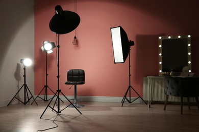 Photo of Different professional lighting equipment in modern photo studio