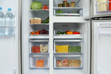 Open refrigerator full of different fresh products