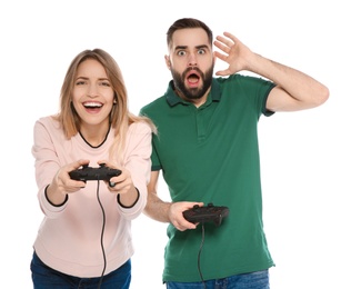 Emotional couple playing video games with controllers isolated on white