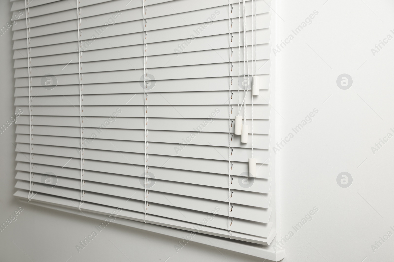 Photo of Window with closed blinds in room, closeup