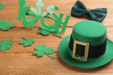 Photo of Leprechaun's hat and St. Patrick's day decor on wooden table