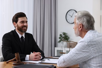 Senior man having meeting with lawyer in office