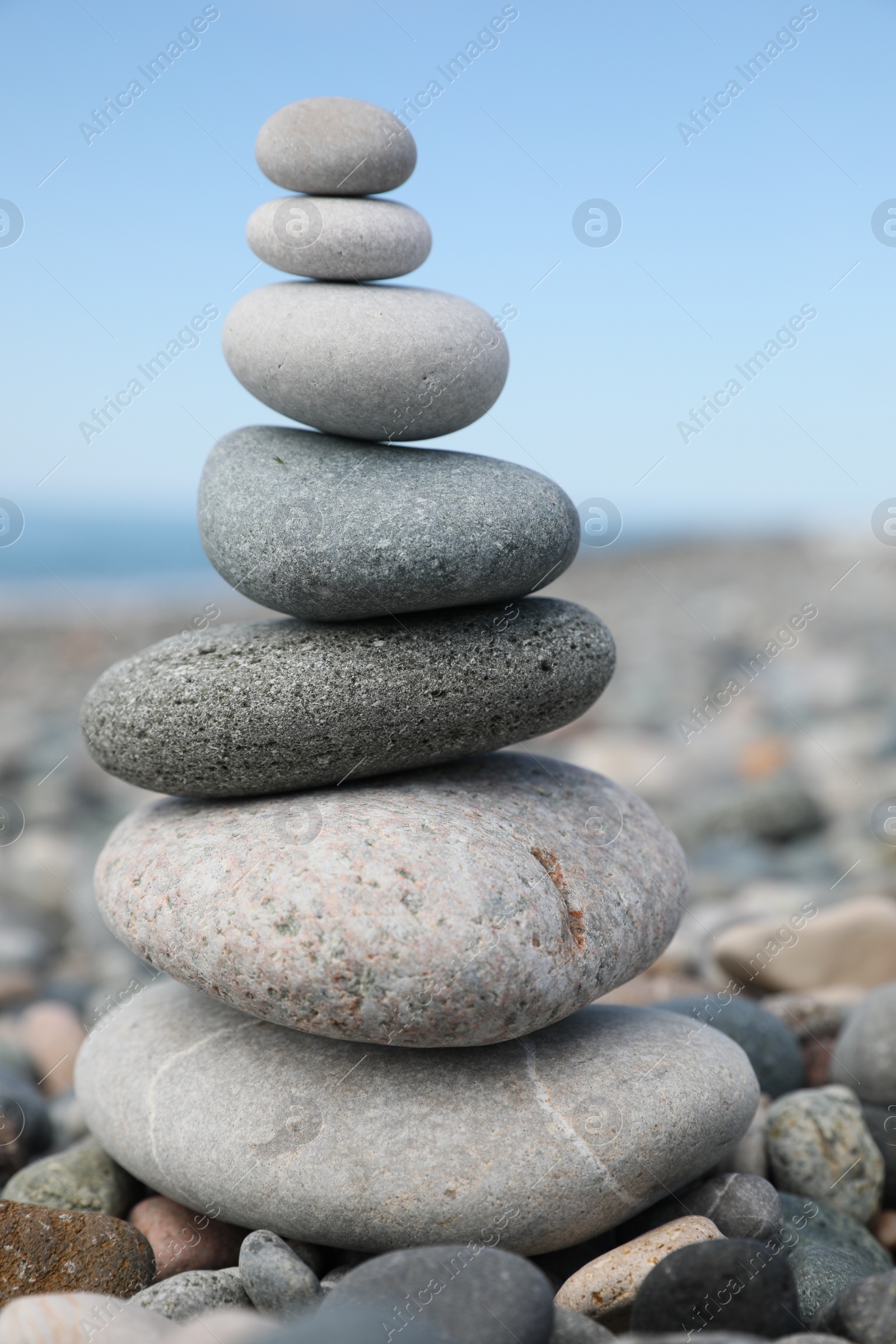 Photo of Stack of stones on beach against blurred background, closeup