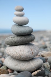 Photo of Stack of stones on beach against blurred background, closeup