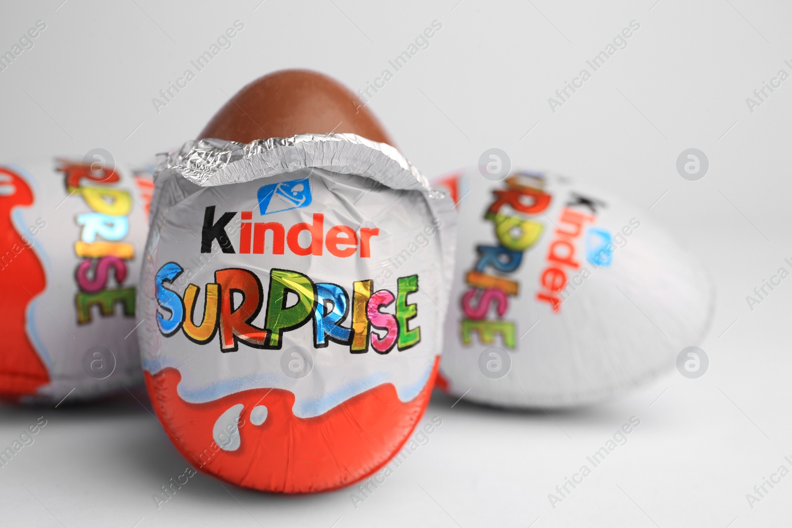 Photo of Sveti Vlas, Bulgaria - June 27, 2023: Kinder Surprise Eggs on white background, closeup. Space for text