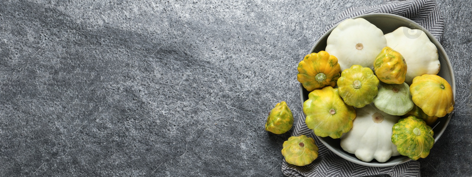 Image of Fresh pattypan squashes on grey table, flat lay with space for text. Banner design