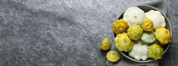 Fresh pattypan squashes on grey table, flat lay with space for text. Banner design