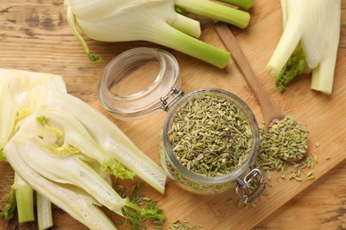 Photo of Fennel seeds in jar and fresh vegetables on wooden table, top view
