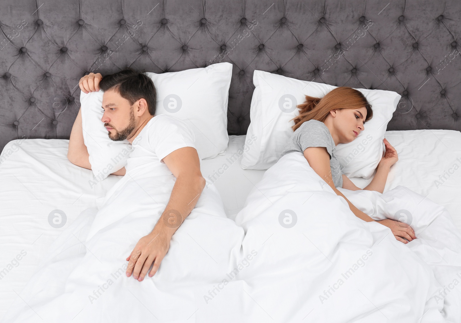 Photo of Couple with relationship problems in bed at home