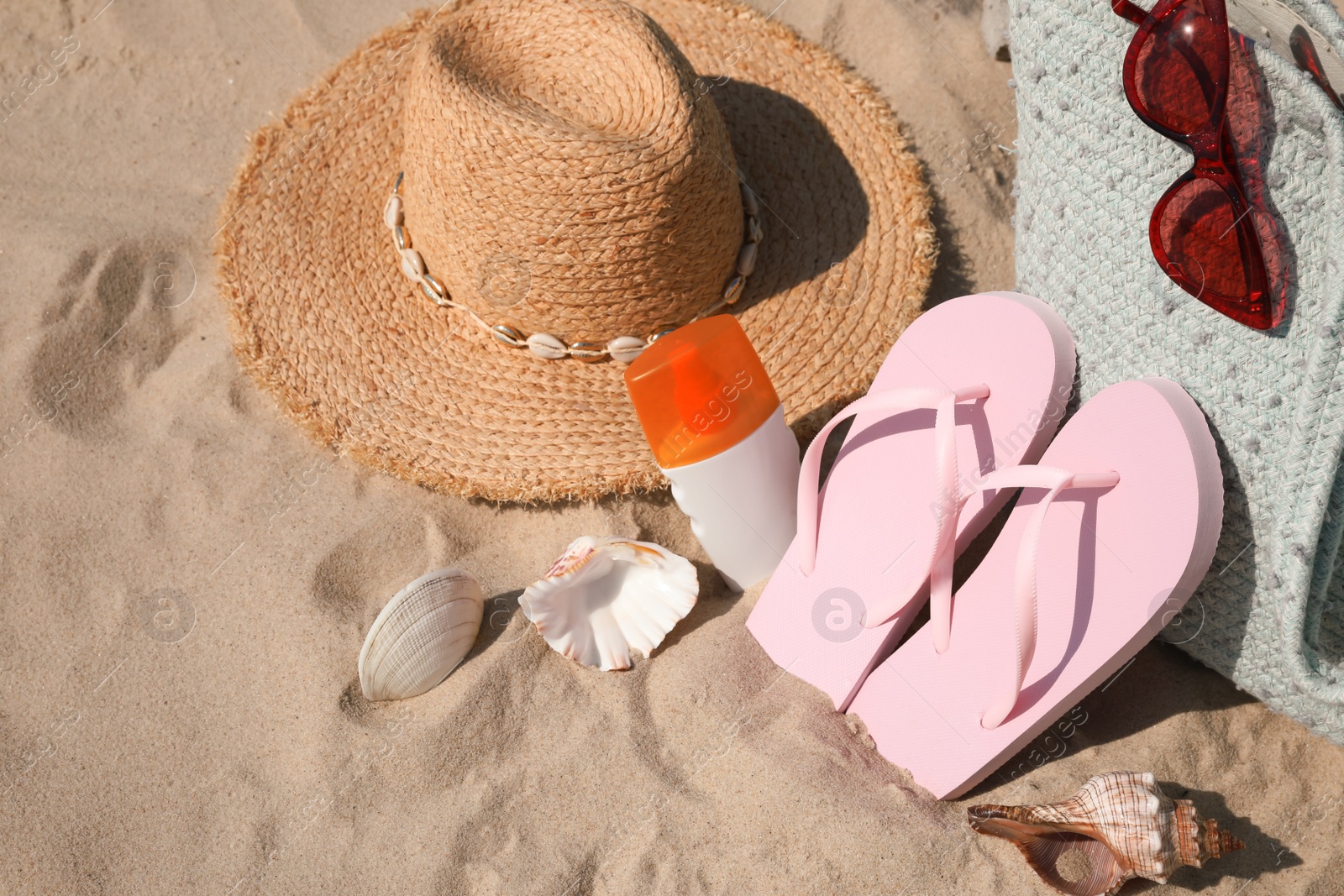 Photo of Bag and beach accessories on soft sand