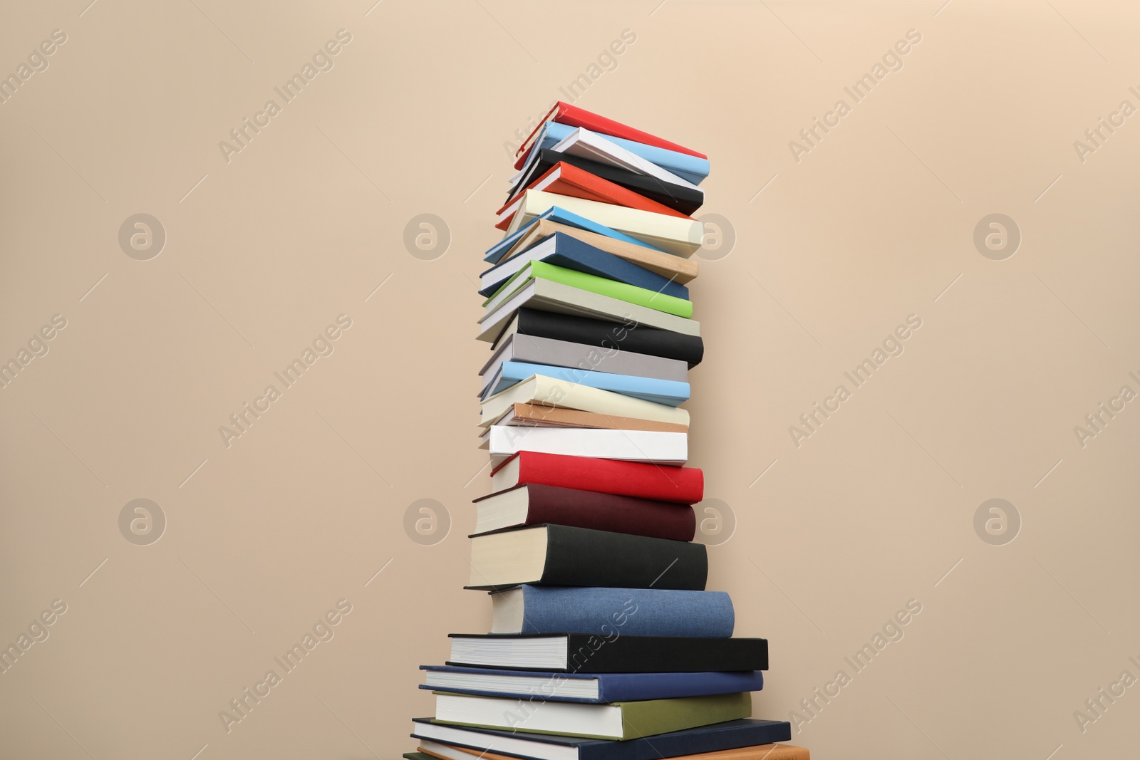 Photo of Stack of hardcover books on beige background