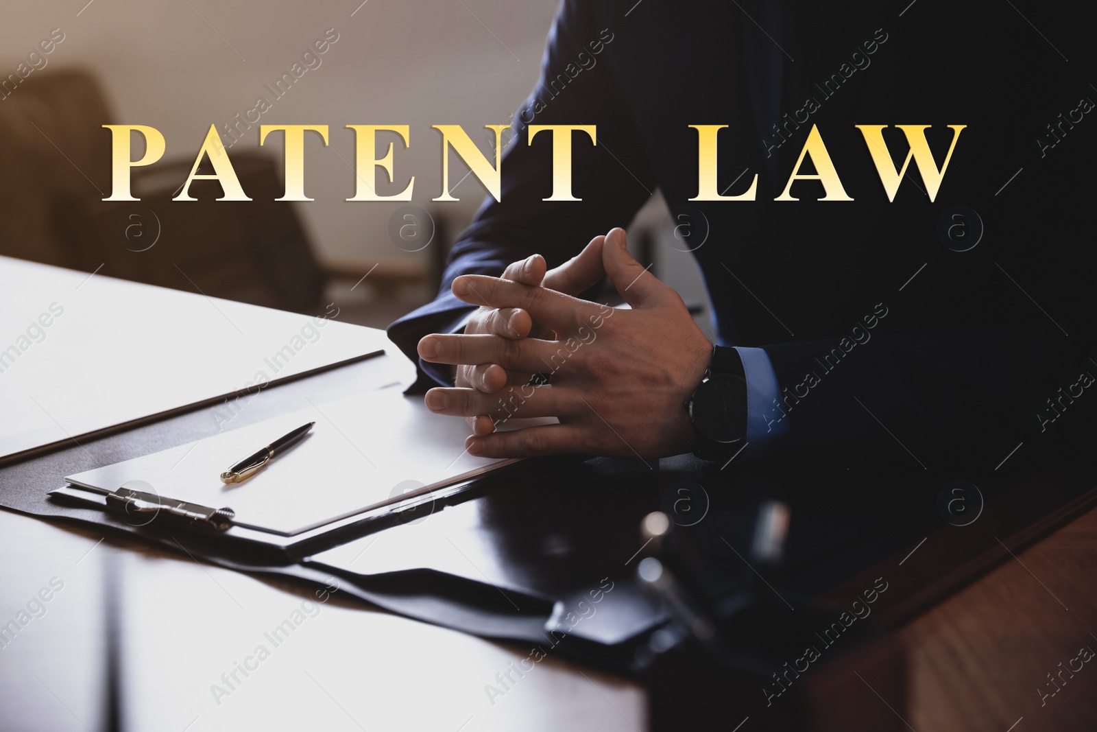 Image of Male lawyer at table in office, closeup. Patent Law