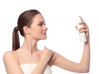 Photo of Young woman applying thermal water on face against white background. Cosmetic product