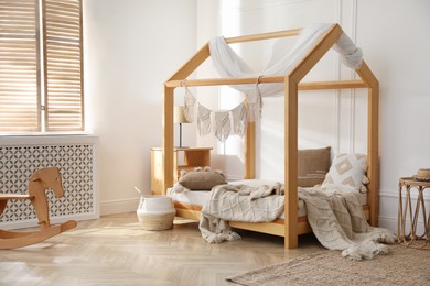 Photo of Stylish child room interior with house bed
