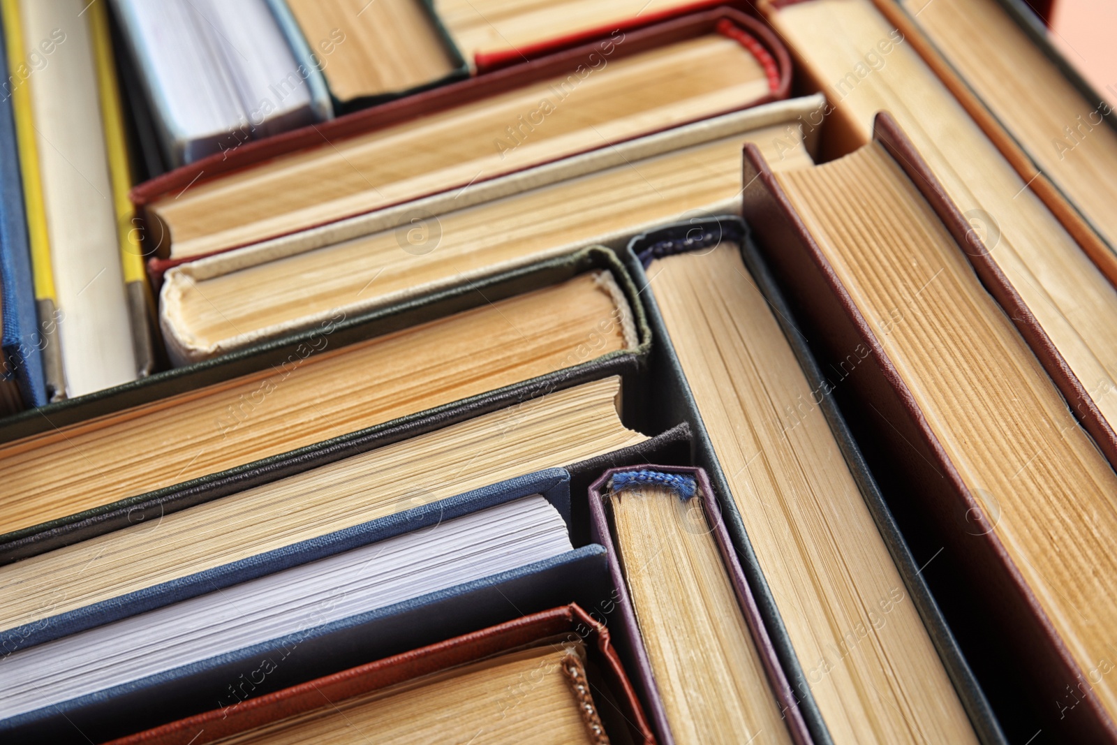 Photo of Many different hardcover books as background, closeup