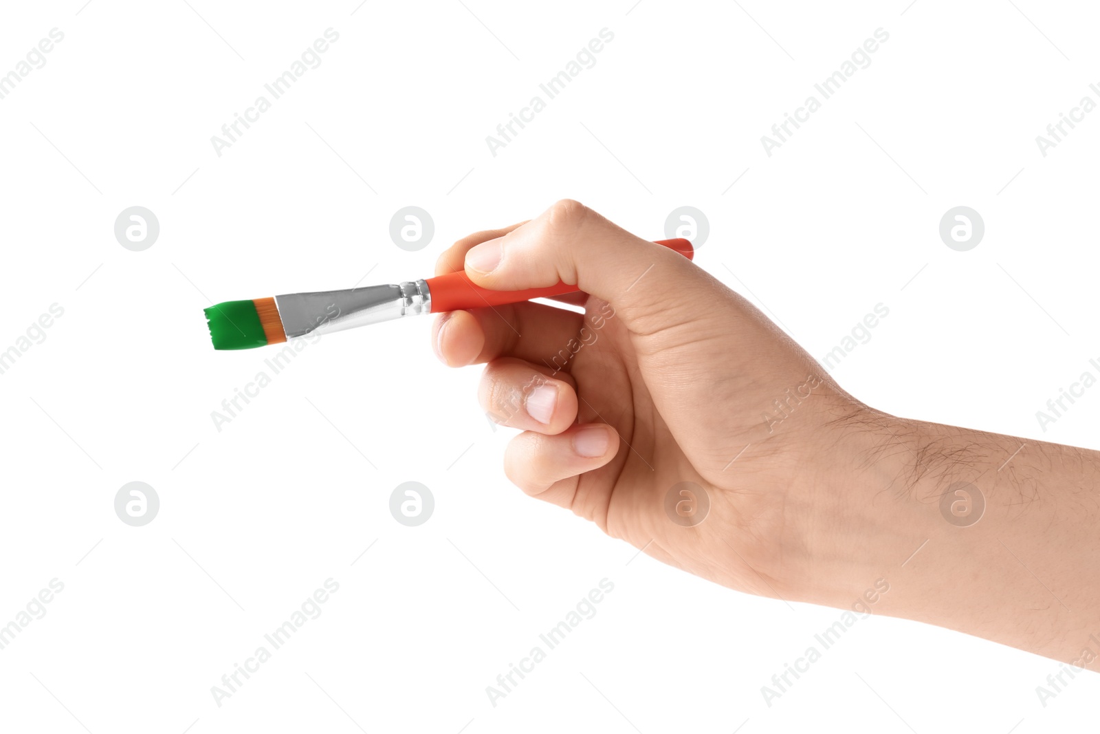 Photo of Young man holding brush with color paint on white background, closeup