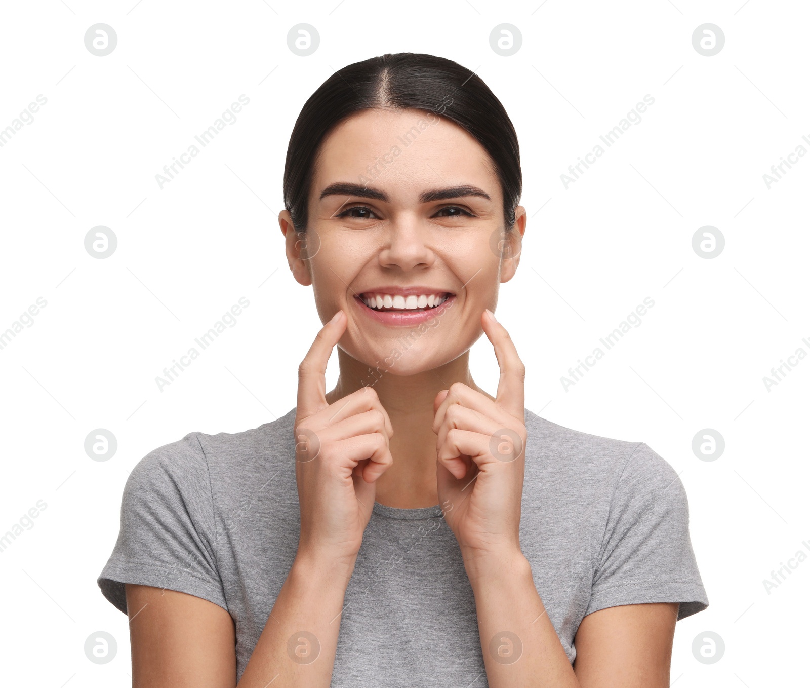 Photo of Young woman showing her clean teeth and smiling on white background