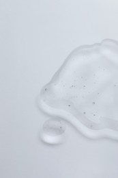 Photo of Sample of cosmetic oil on light surface