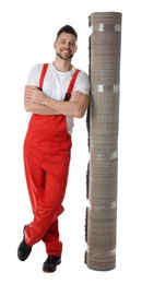 Photo of Male worker with rolled carpet on white background