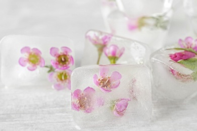 Floral ice cubes on table, closeup view