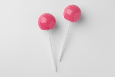 Tasty lollipops on white background, flat lay