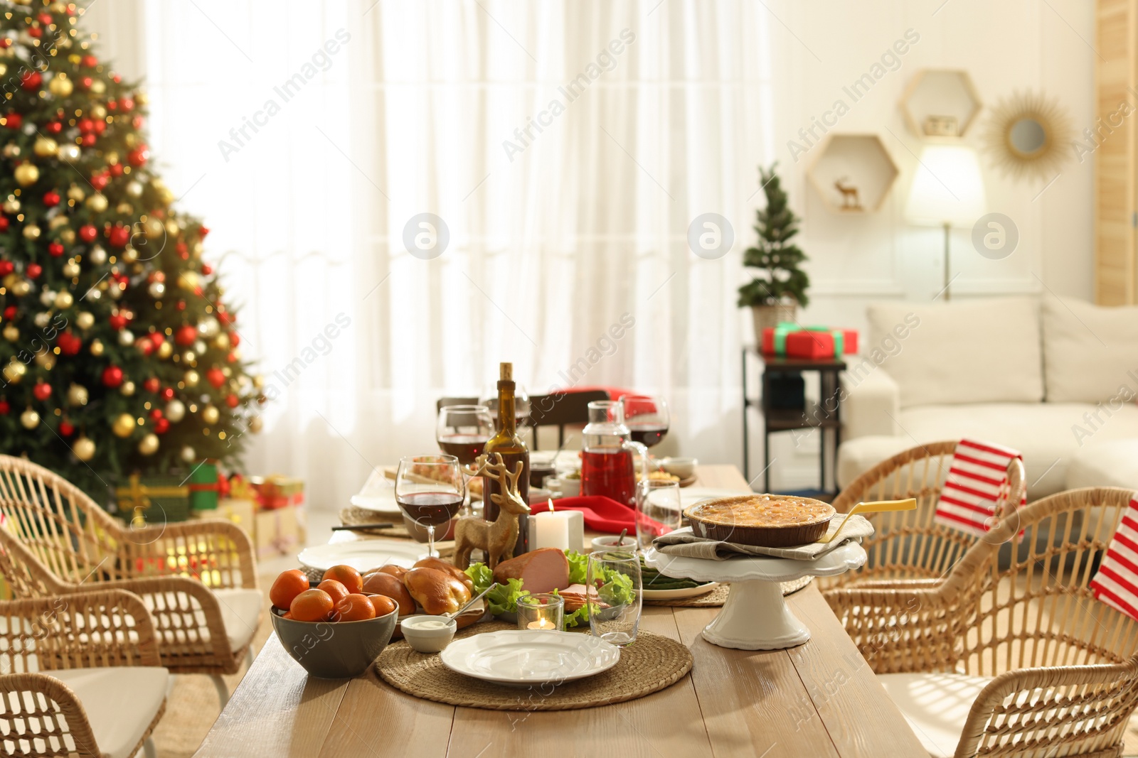 Photo of Festive dinner with delicious food and wine on table indoors. Christmas celebration