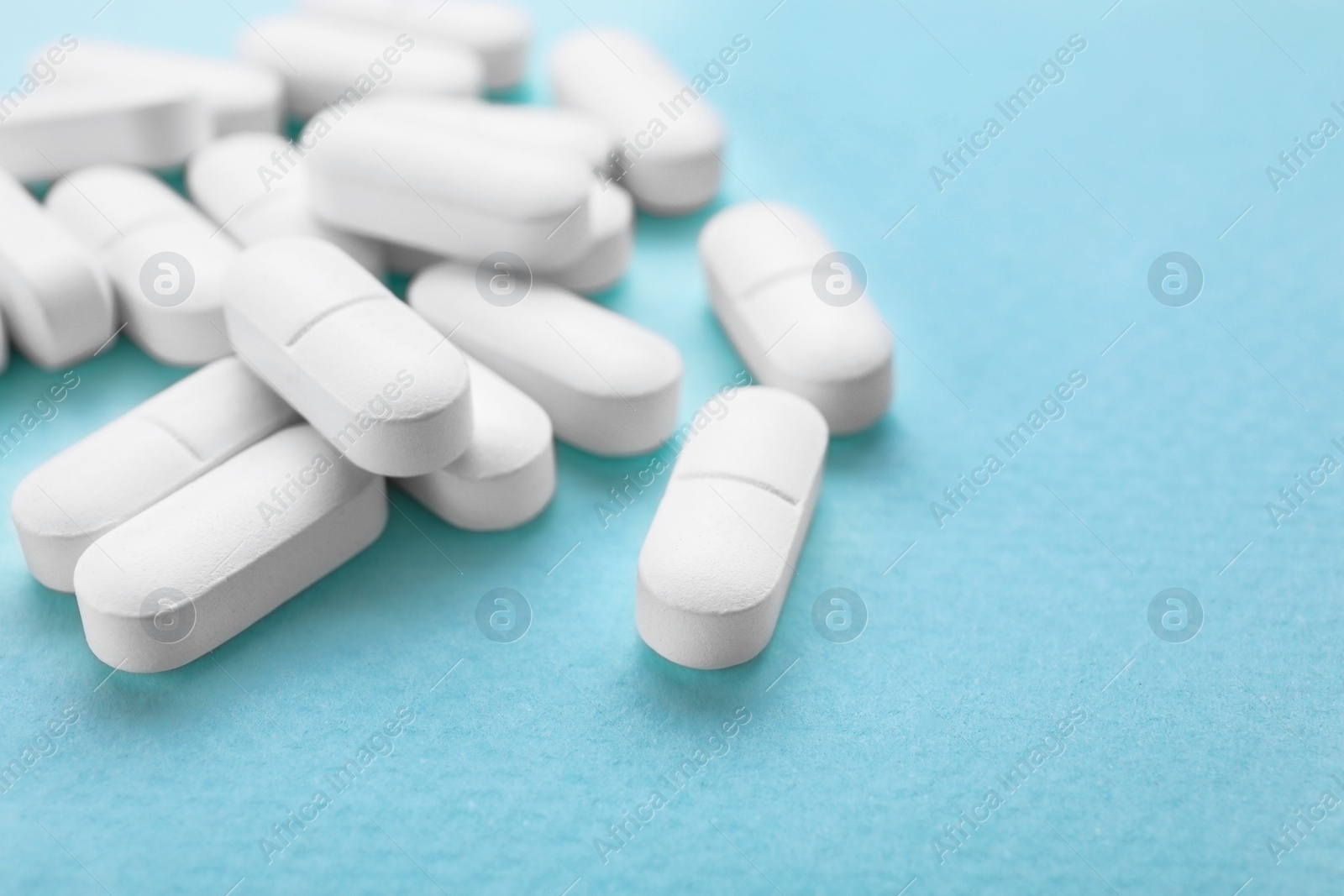 Photo of Antidepressants on light blue background, closeup. Space for text