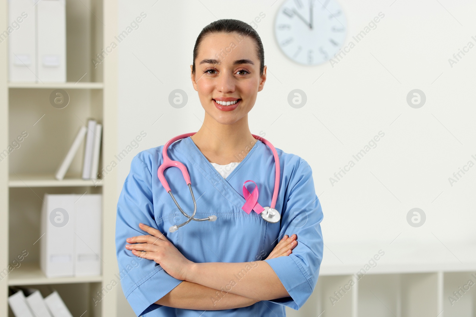 Photo of Mammologist with pink ribbon in hospital. Breast cancer awareness