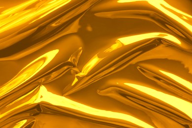 Image of Shiny crumpled golden foil as background, closeup