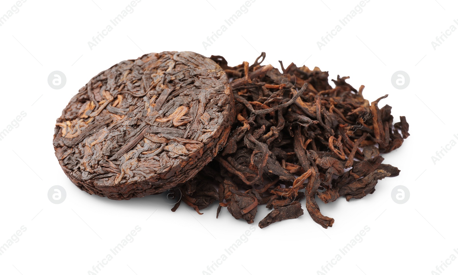 Photo of Disc shaped traditional Chinese pu-erh tea and leaves isolated on white