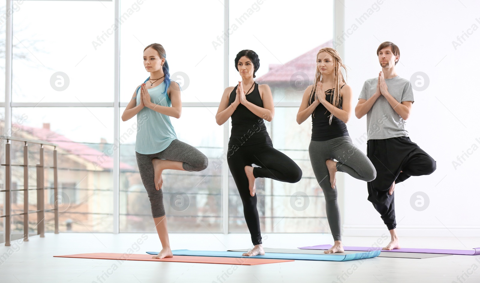 Photo of Group of people practicing yoga indoors