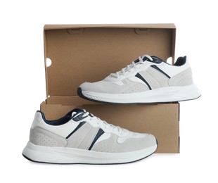 Pair of stylish sport shoes and cardboard box on white background
