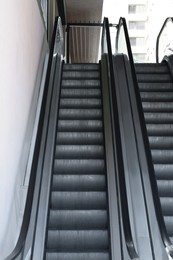Photo of View on empty parallel escalators with grey balustrades
