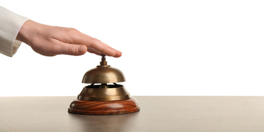 Woman ringing hotel service bell at grey stone table