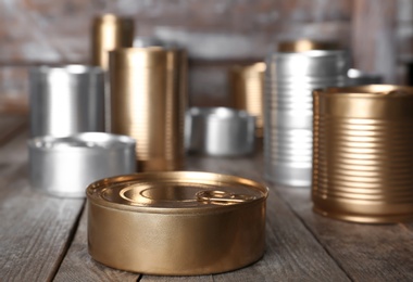 Photo of Many tin cans on table. Recycling garbage