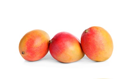 Delicious ripe juicy mangoes on white background