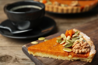 Piece of fresh homemade pumpkin pie on wooden table