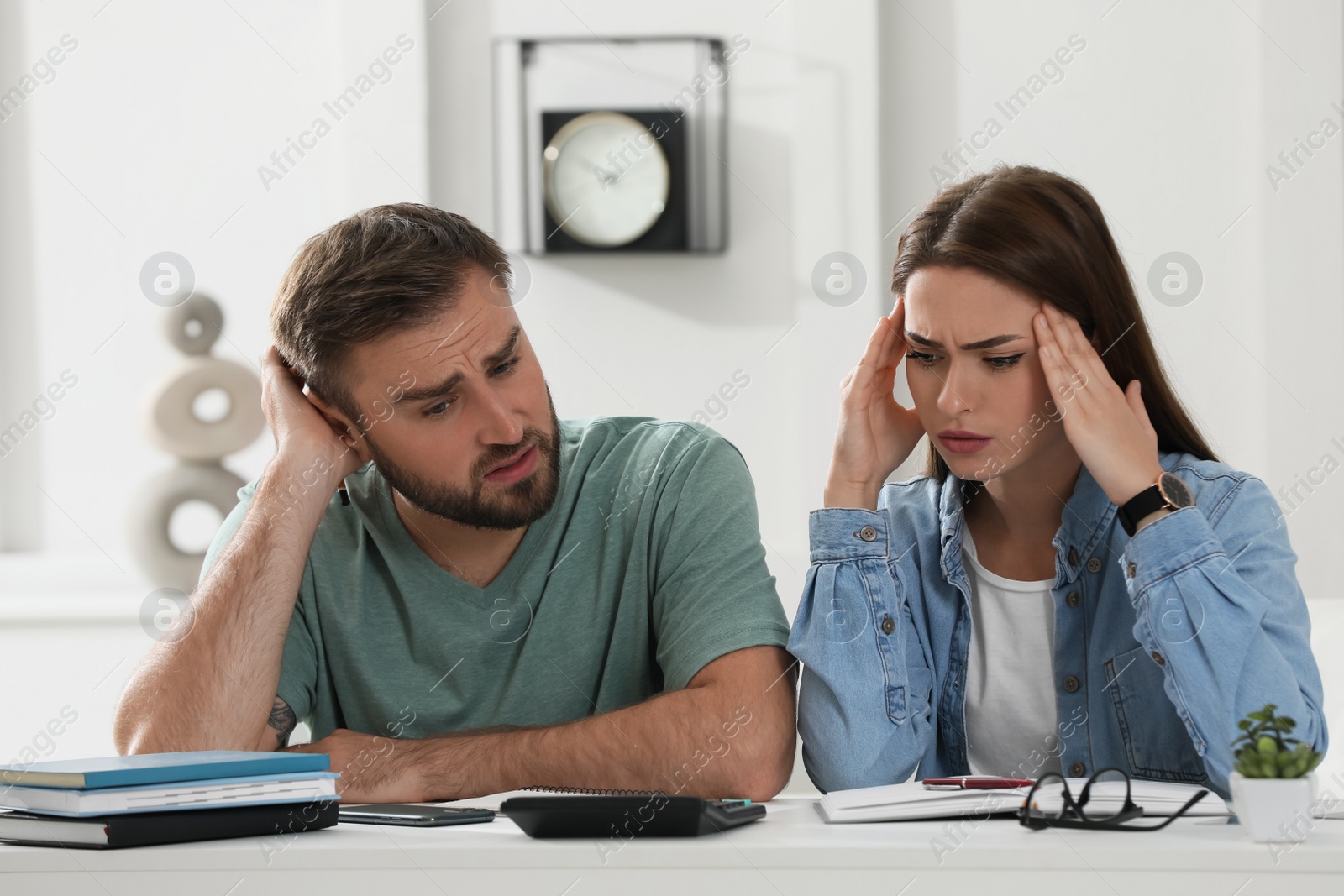 Photo of Young couple discussing family budget at home