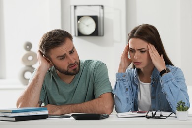 Young couple discussing family budget at home