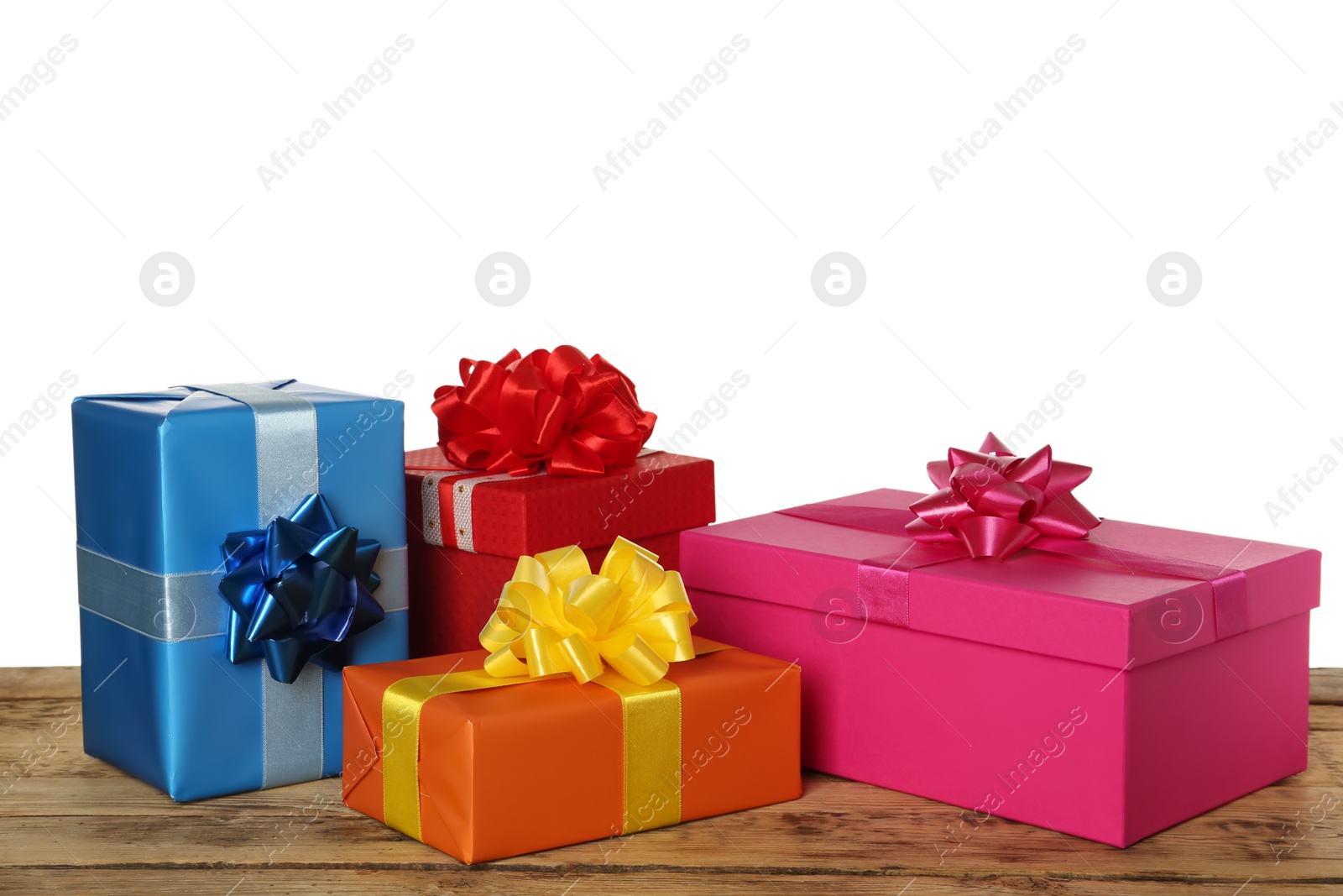 Photo of Colorful gift boxes on wooden table against white background